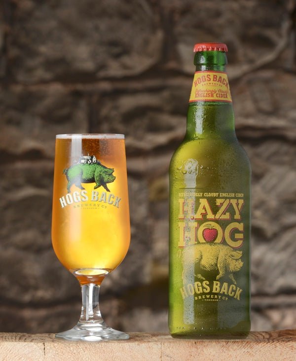 Bottle of Hazy Hog apple cider with half pint glass - Hazy Hog Cider x12 - Hogs Back Brewery