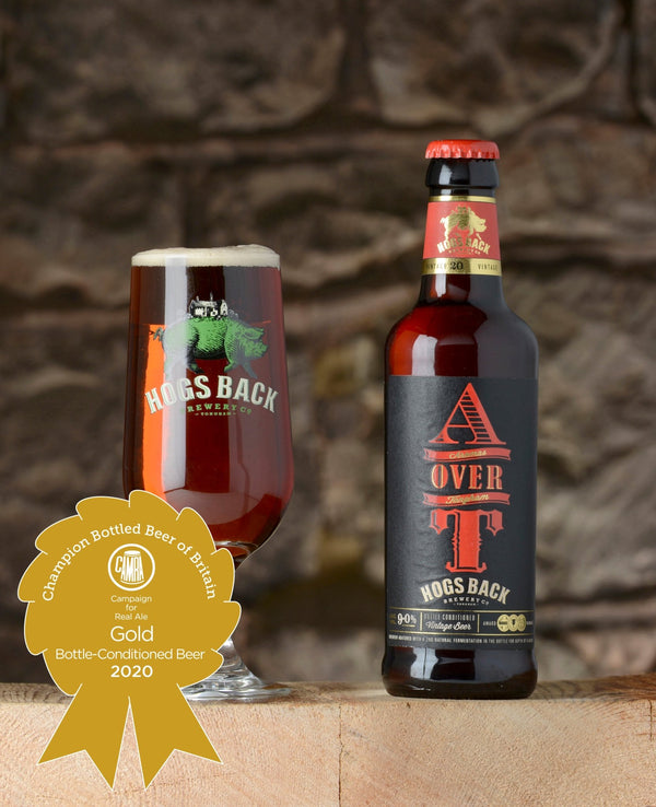 A over T Barley Wine beer bottle and half pint beer glass with Champion Bottled Beer of Britain Gold medal - A over T - Champion Bottled Beer of Britain 2020 - Hogs Back Brewery